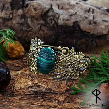 Viking women’s bronze cuff with ornate filigree and malachite