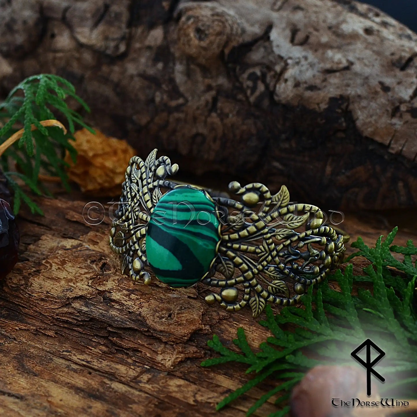 Viking women’s bronze cuff with ornate filigree and malachite